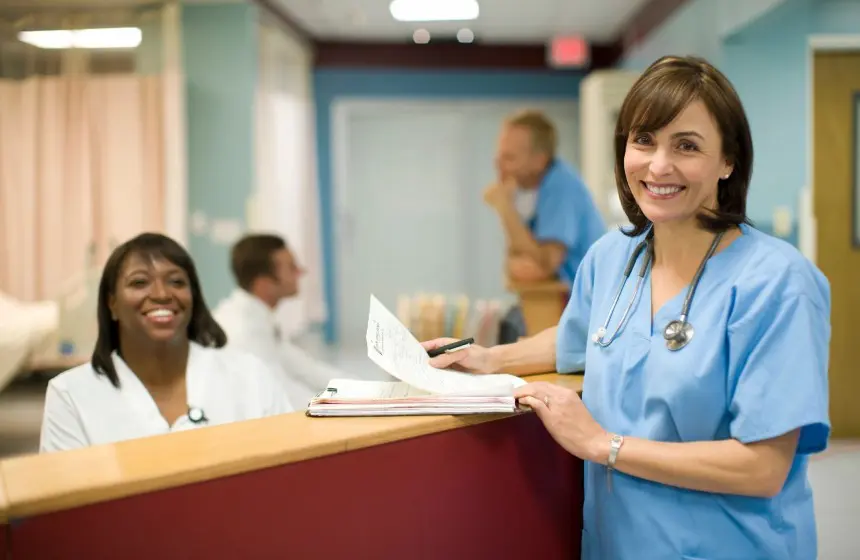 Female doctor with receptionist in hospital